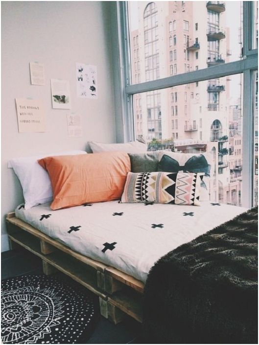 The narrow pallet bed is a secluded corner of the bedroom with incredible city views.