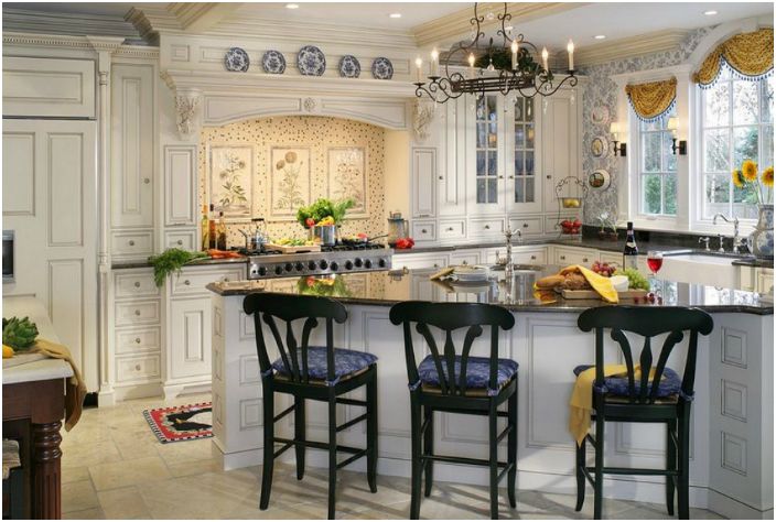 Elegantiška pastelinių spalvų virtuvė su dailiais baldais ir paauksuotomis detalėmis.