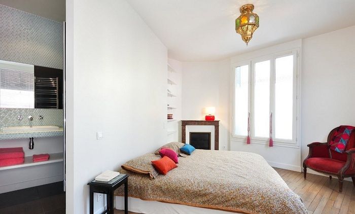 Украсить светлый интерьер спальной возможно благодаря ярким элементам декора.