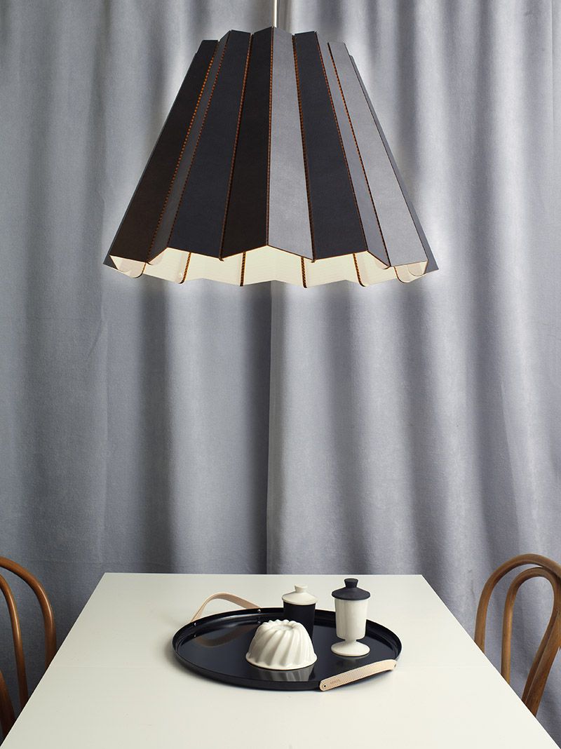 Необычный подвесной светильник с чёрным абажуром над обеденным столом